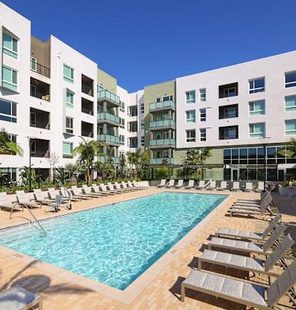 Park on First Apartments Pool Area with Lounge Chairs