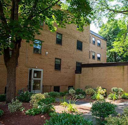 a brick building with a courtyard in front of it