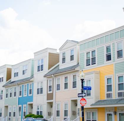a row of colorful condominiums on a street