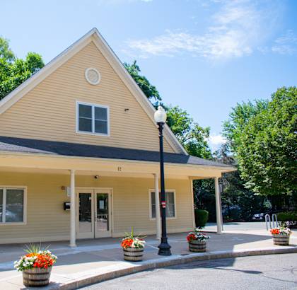a yellow building with a black lamp post in front of it