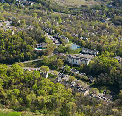 A bird's eye view of a residential area surrounded by trees.