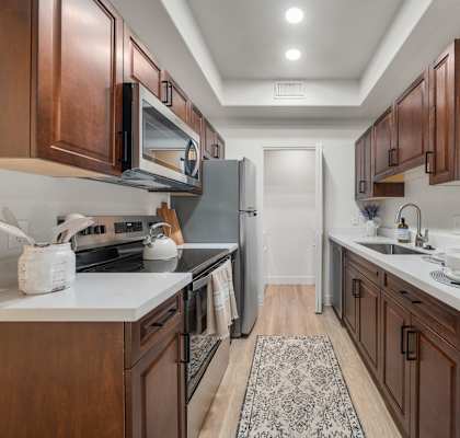 A kitchen with brown cabinets and a white countertop.