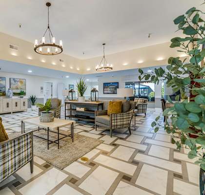 A well-lit, spacious lobby with a variety of seating options and a plant on the right.