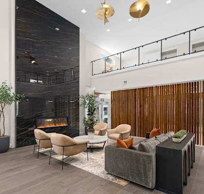 A modern living room with a fireplace and a balcony.