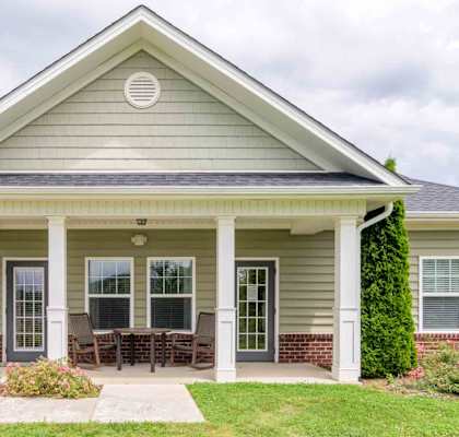 A house with a covered front porch and a covered patio.