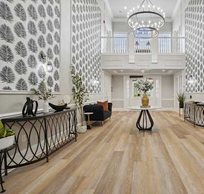 the lobby of a hotel with couches and a table