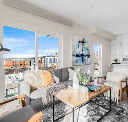 a living room with a couch and a coffee table and a kitchen  at Oslo, Seattle, Washington