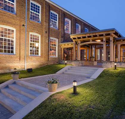 the facade of a large brick building at night