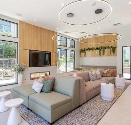 A living room with a grey couch and a television.