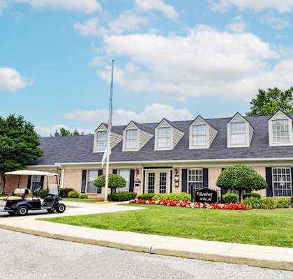 a house with a golf cart parked in front of it