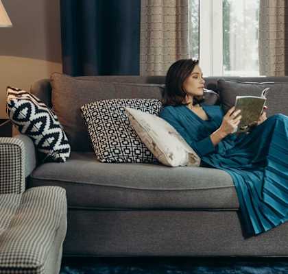 woman lying on a couch in nicely decorated apartment