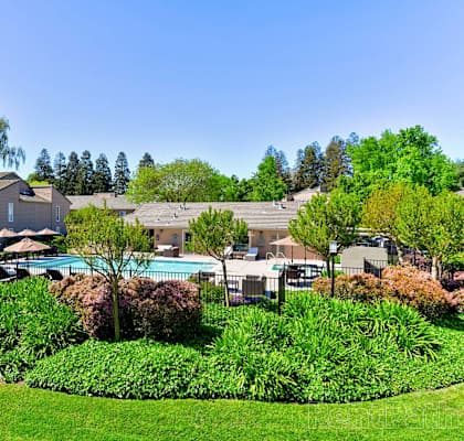 building exterior and pool at The Seasons Apartments in San Ramon, CA