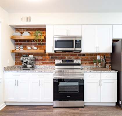a kitchen with stainless steel appliances and white cabinets