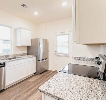 a kitchen with granite counter tops and stainless steel appliances