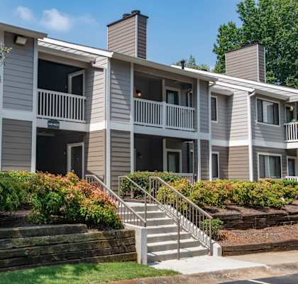 an apartment building with stairs and balconies