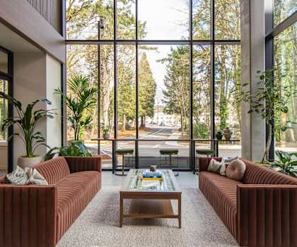 A living room with a large window and a coffee table.