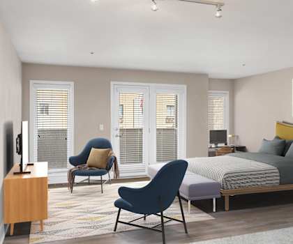 a bedroom with a bed and a chair in a room