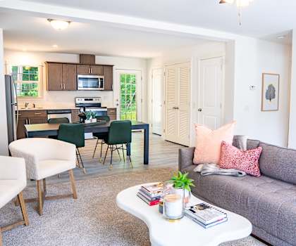 a living room with a gray couch and a white coffee table at Hangar Flats, Batavia Ohio
