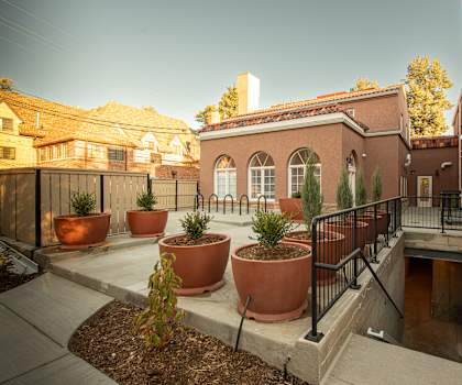 A courtyard with a building and potted plants.at 891 Exchange, Boulder, CO