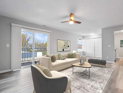 A living room with a white couch and a grey chair at Parkview of Lebanon Apartments, Lebanon, Indiana