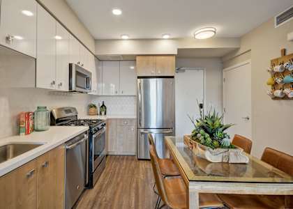 a kitchen with stainless steel appliances and a table with chairsat L Seven, CA 94103