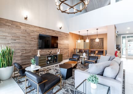 a living room filled with furniture and a large chandelier