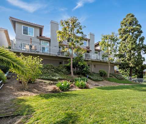 a large fenced shared backyard space