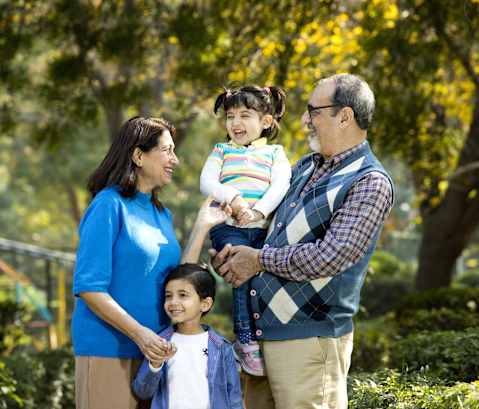 a family poses for a picture in a park
