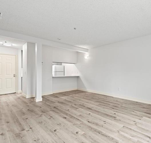 A room with a white wall and a wooden floor. at Stony Creek Apartments, Santa Rosa, 95401