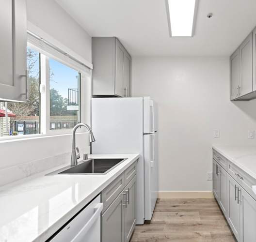 A kitchen with white appliances and cabinets. at Stony Creek Apartments, Santa Rosa, 95401