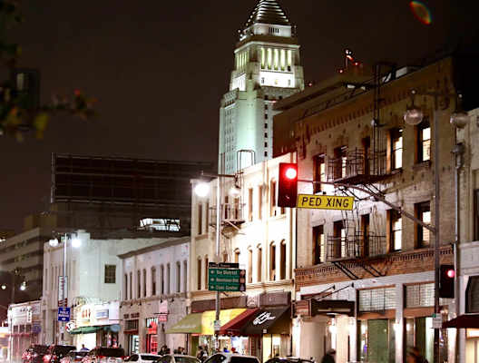 a city street at night with a traffic light at Mikado Little Tokyo, Los Angeles, CA