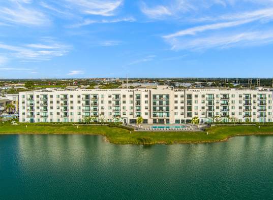 an aerial view of an apartment building overlooking the water