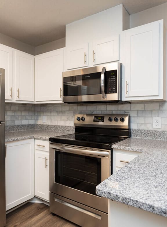 an empty kitchen with wooden cabinets and stainless steel appliances