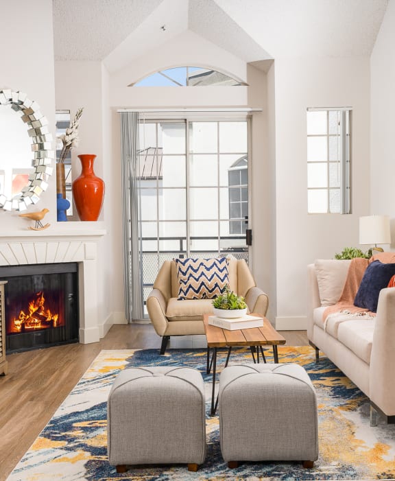 Living room with a large window and a wooden floor at The Preston Miracle Mile Apartments, Los Angeles, CA, California