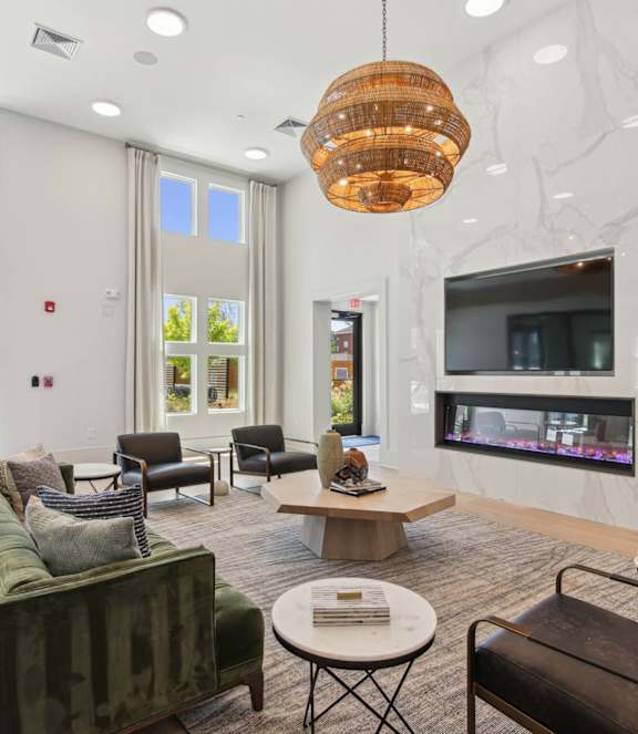A modern kitchen with white cabinets and stainless steel appliances.
