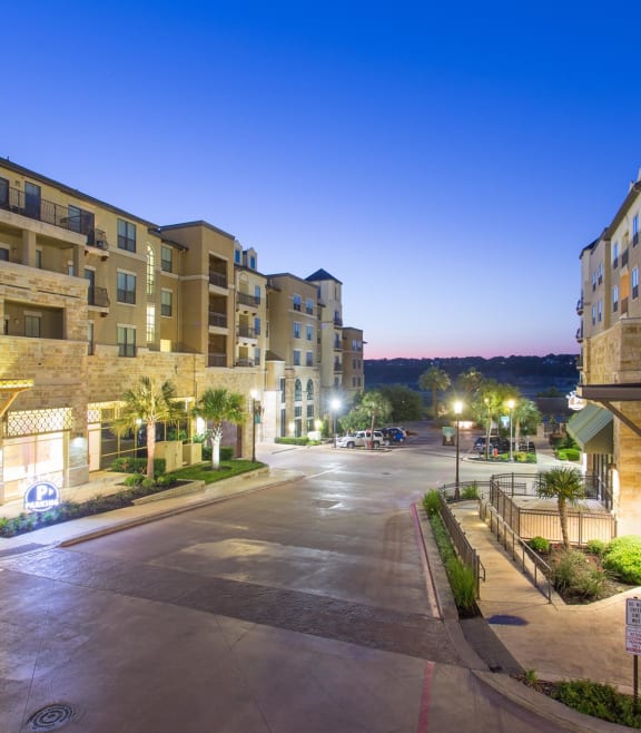 Outdoor view at dusk of Artessa at Quarry Village's Alamo Heights apartments
