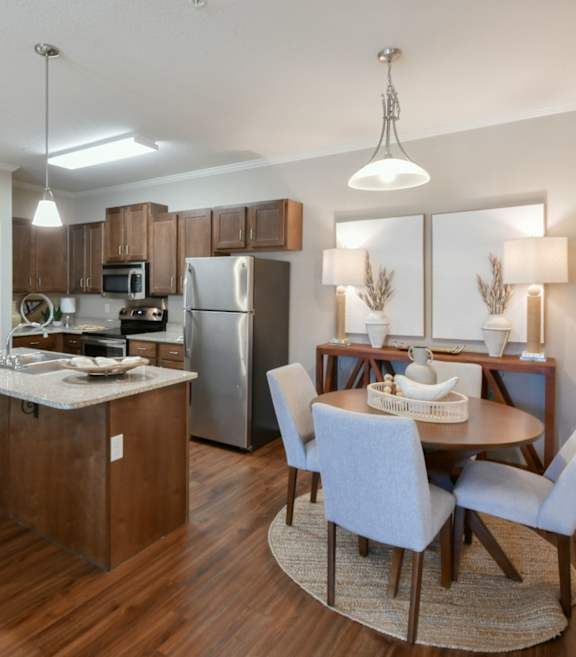 A kitchen with a dining table and chairs. at Hall Creek Apartment Homes, Arlington, Tennessee