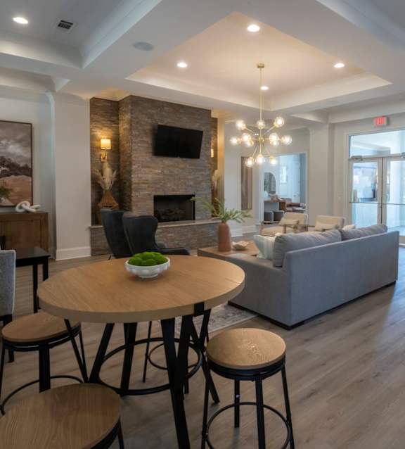 A living room with a fireplace and a couch. at Hall Creek Apartment Homes, Arlington, Tennessee