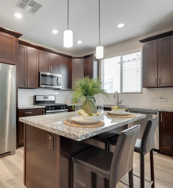 Kitchen and living room at Bella Victoria Luxury Apartments in Mesa AZ