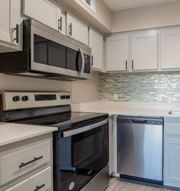 a kitchen with white cabinets and stainless steel appliances  at Sofia Apartments, Tempe, AZ, 85283