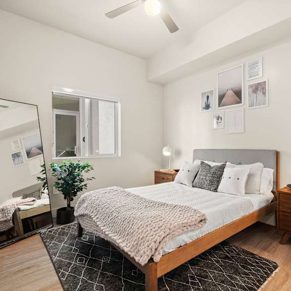 a bedroom with a large bed and a mirror at SECOND AVE COMMONS | BRAND-NEW, Mesa