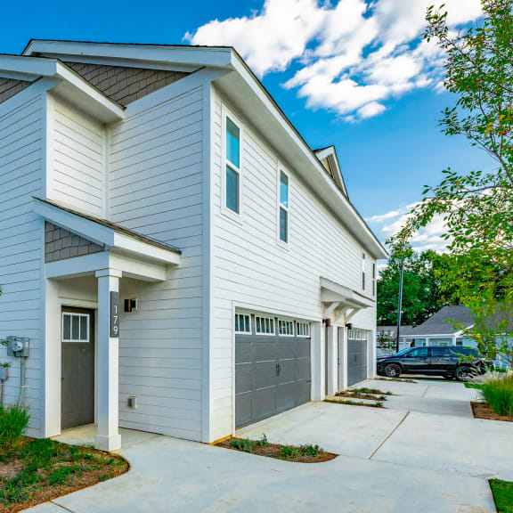 a white house with a driveway and a garage door