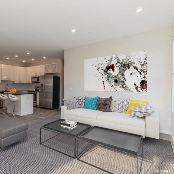 a living room with a couch and a coffee table in front of a kitchen at Solo at North Bergen, North Bergen, 07047