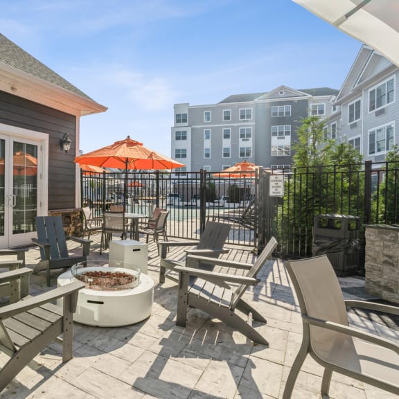 a patio with chairs and a fire pit and a building at Solo at North Bergen, North Bergen, 07047