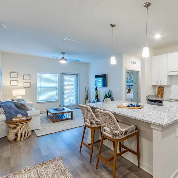 A kitchen with a white countertop and stainless steel appliances.
