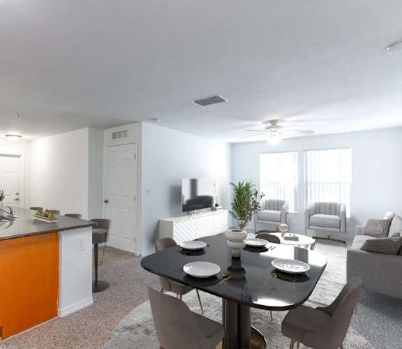 A modern kitchen with a dining table set for two.