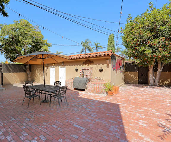 A patio with a table and chairs under a canopy.