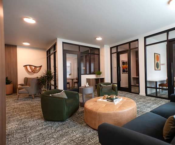 A living room with a green couch and a wooden coffee table.
