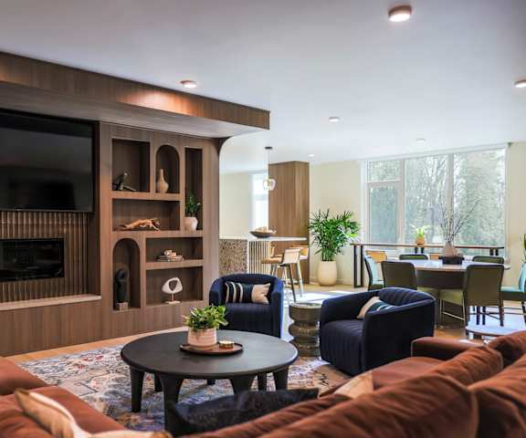A living room with a brown sofa set and a television.