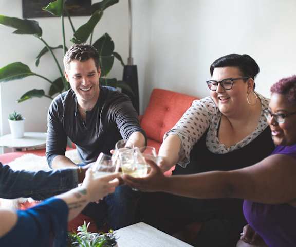 A group of people toasting with glasses of wine.